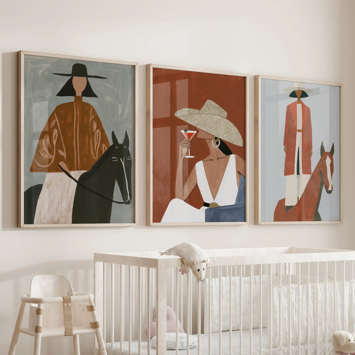 Modern ranch lifestyle, a set of three large wall art prints in wooden frames, calms the baby nursery above the cot with gentle western tones.