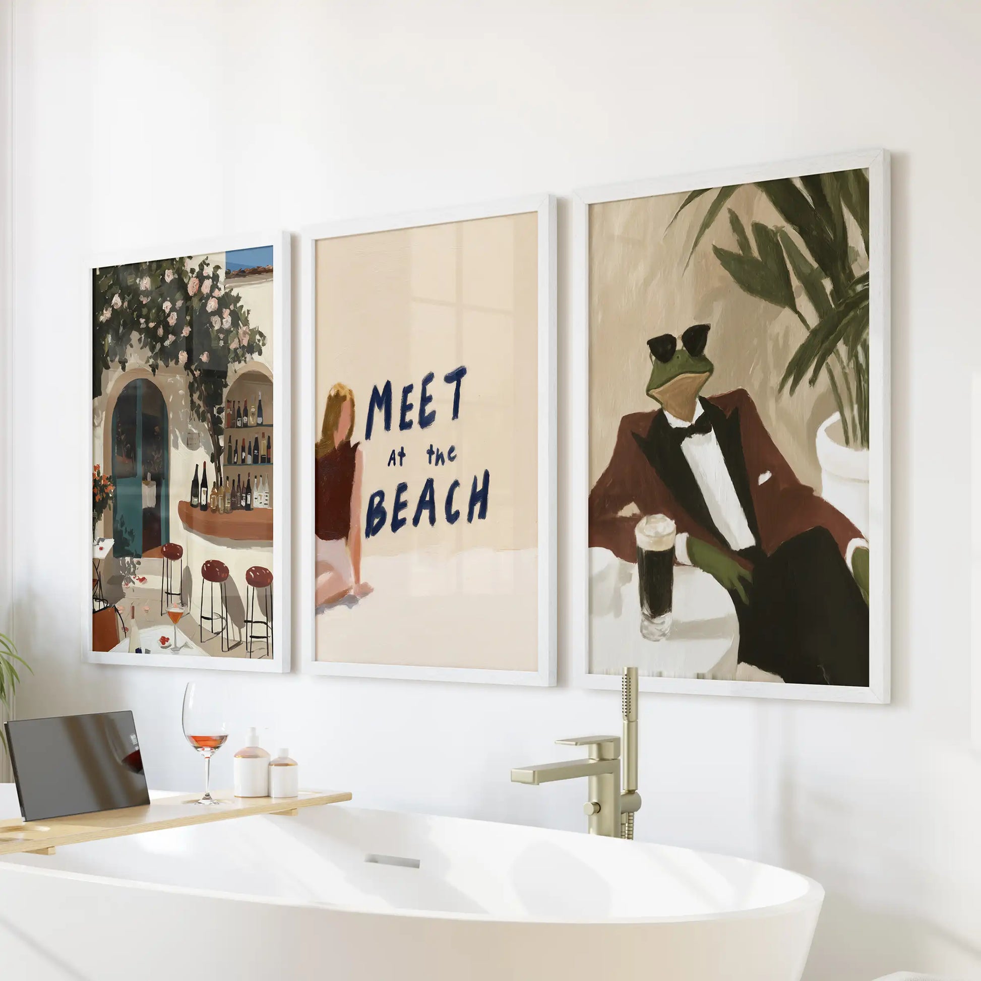 This white-framed trio shows Riviera coastal scenes that brighten the bathroom when arranged neatly over the bath.