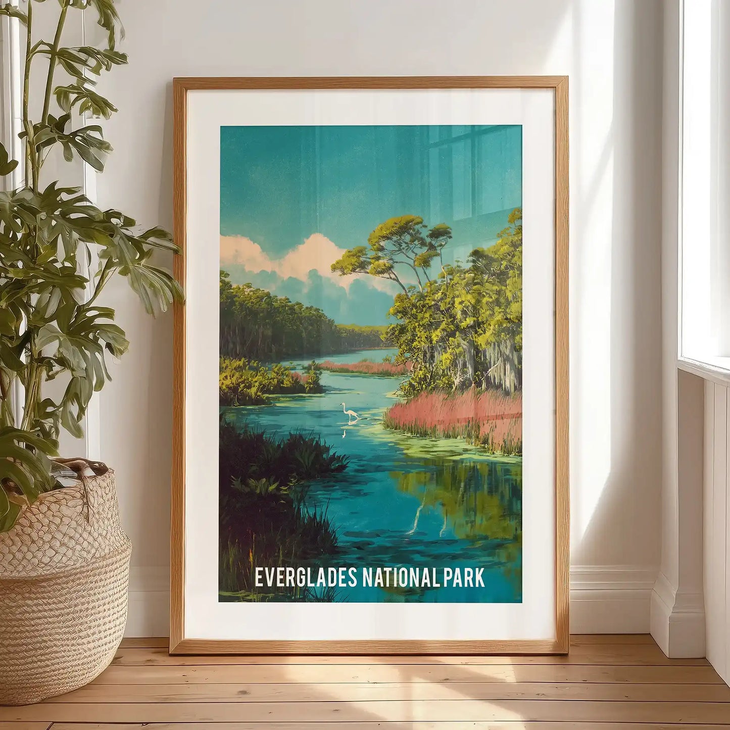 Mangrove waterways wall decor print, finished with a black mat frame, stands propped against the bedroom wall by the window, rich with wetland texture.