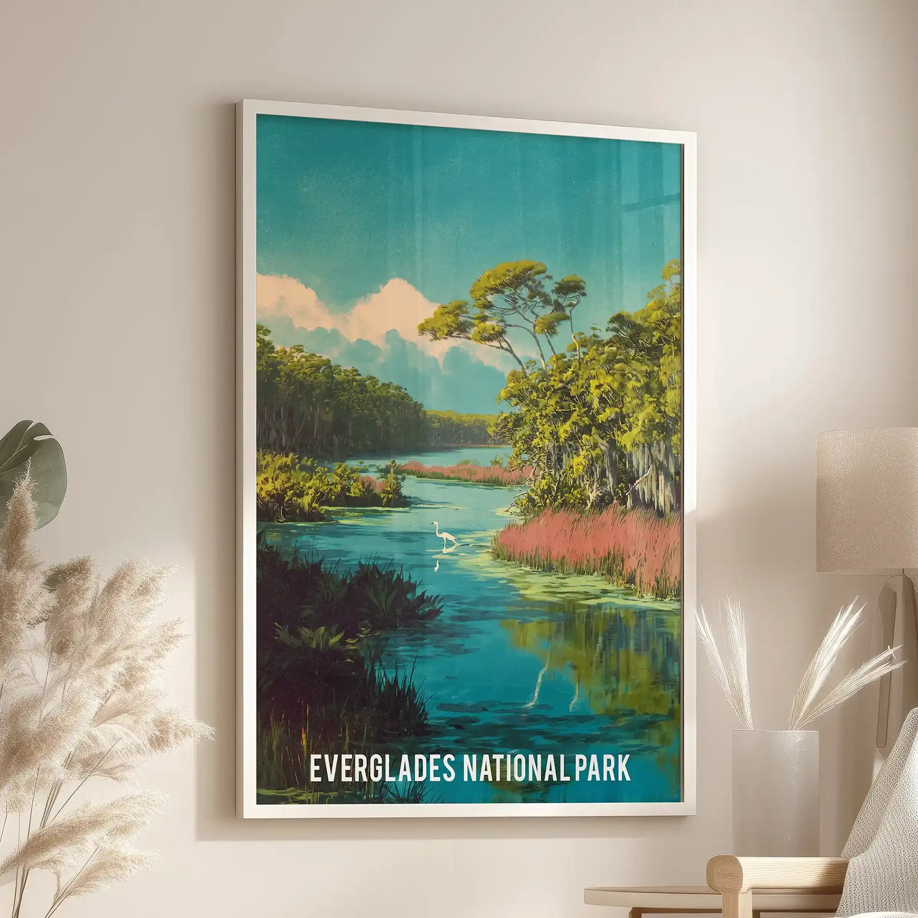 A white-framed artwork print of mangrove forests centers above a chair in the family room, casting a bright, quiet view of Everglades waters.