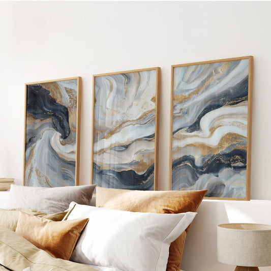 Dark blue texture and brushwork in a trio of wall art pictures settle the bedroom, shown in oak frames hung above the bed.