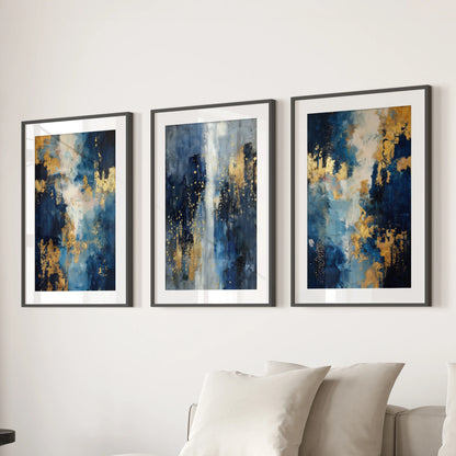Three wide-matted black-framed wall prints with blue and gold textures hang above the living-room sofa, adding a sleek, contemporary polish.