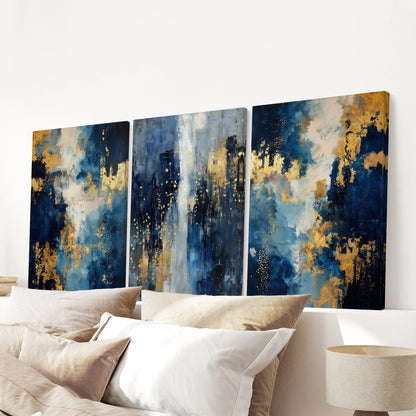 Unframed canvas wall art in a trio of blue-and-gold abstractions spans the bedroom above the bed, creating an airy, contemporary statement.