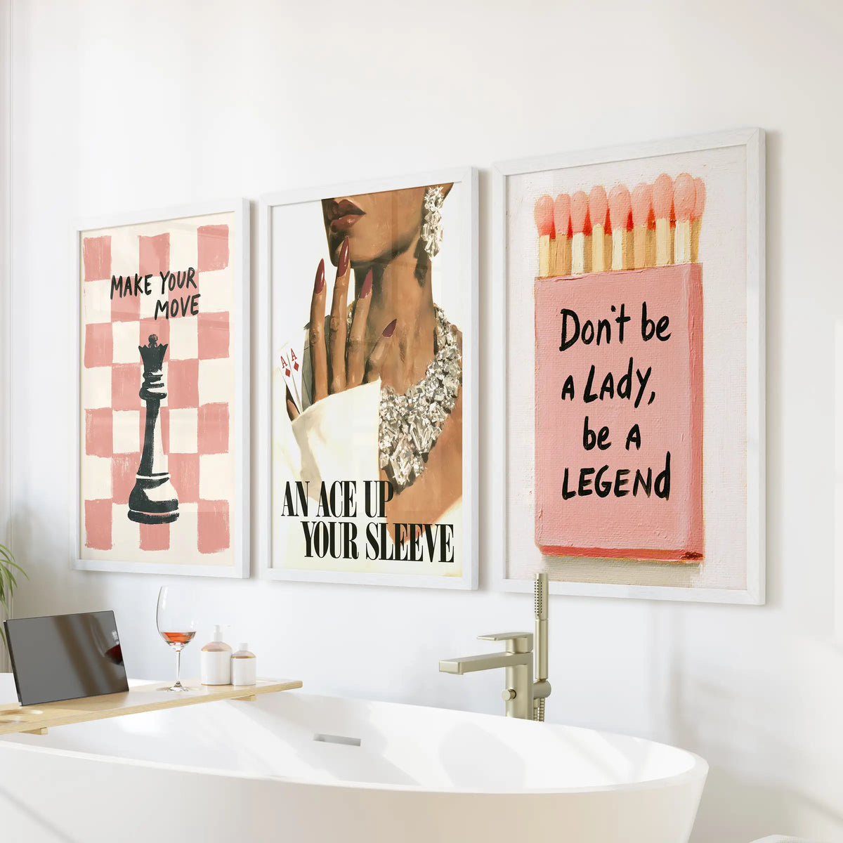 Pink feminine three-piece wall art set in white frames, positioned over the bathtub in a bathroom.
