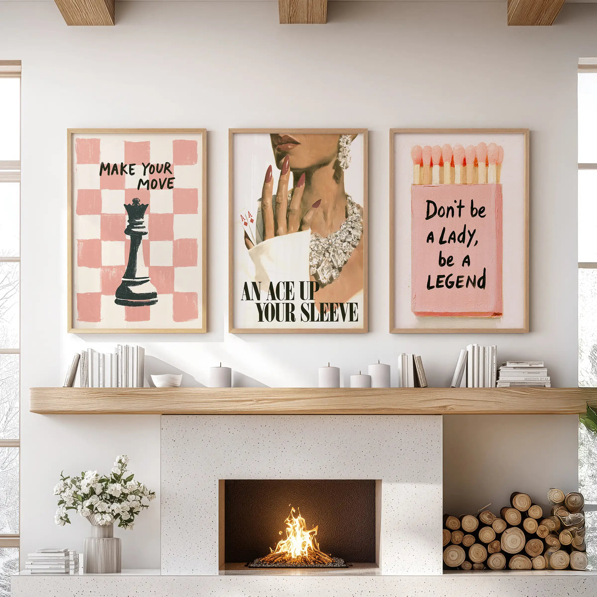 Pink feminine wall art set of three in light wood frames, positioned above the mantel in a living room.