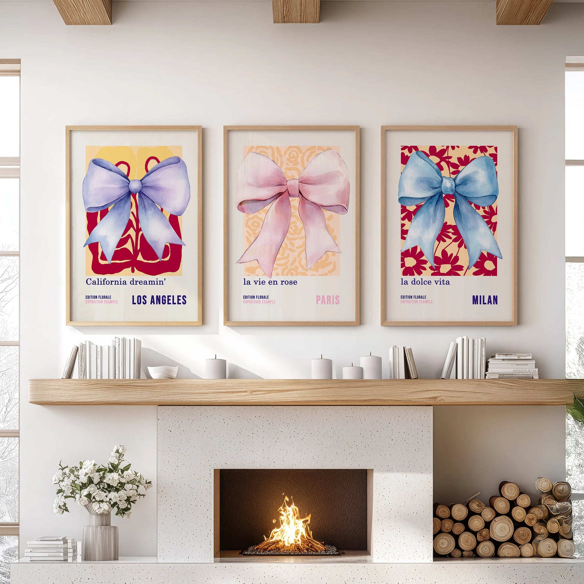 A 3-piece wall art set of blue and pink bows in light oak frames rests above the living room mantel, adding warm, tailored polish.