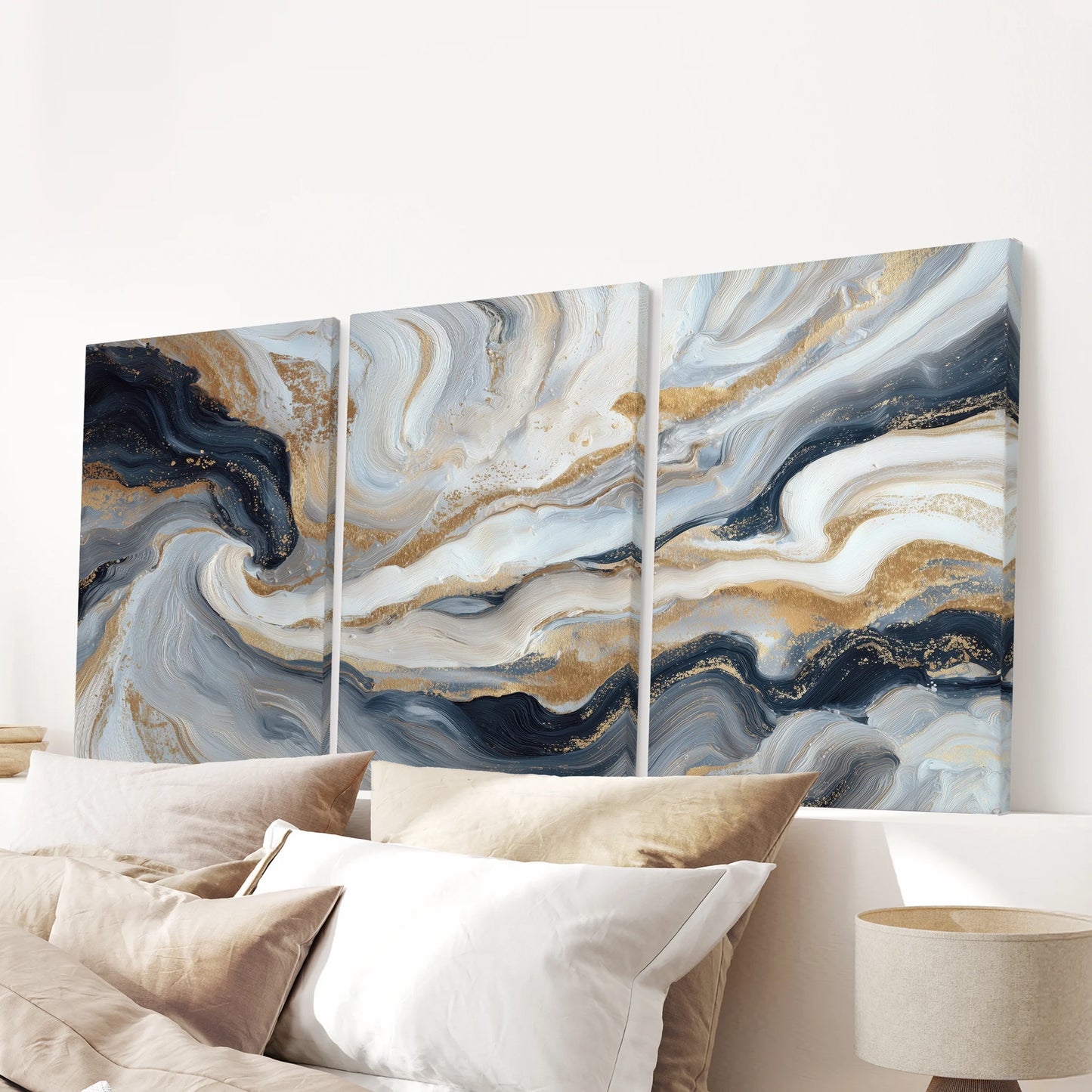 Navy blue brush stroke abstracts in a three-piece canvas wall art set crown the bedroom, centered above the headboard for a crisp, modern finish.
