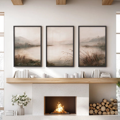 Foggy woodland lake 3-print gallery wall in black frames, displayed above the fireplace in a family room with a sofa and built-in shelves.