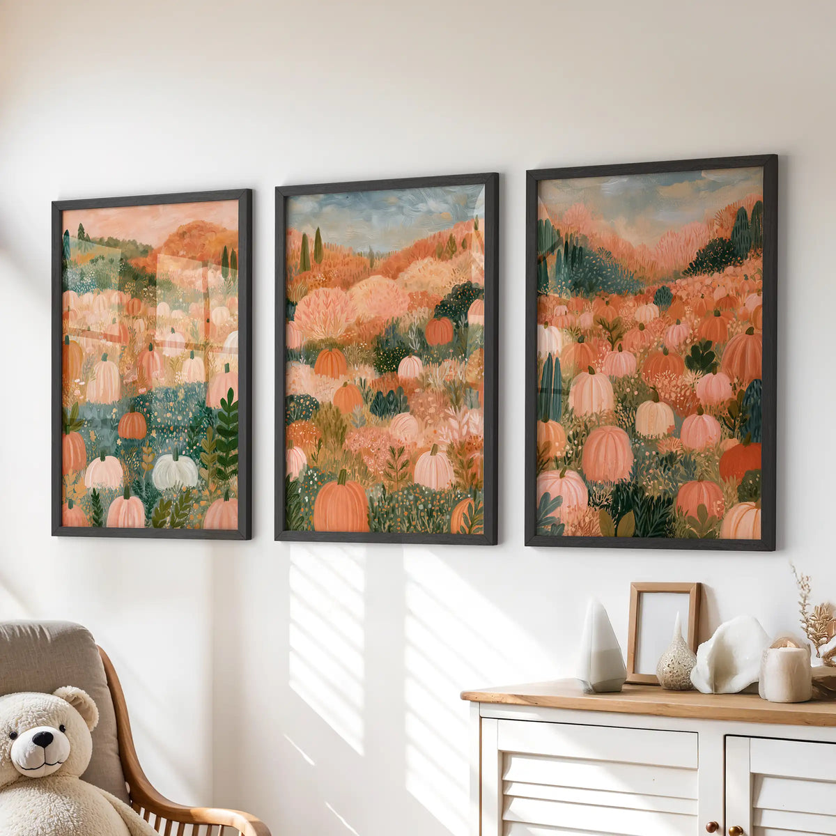 Folk art pumpkins, a wall art trio in black frames, sits neatly over the children's chest of drawers to add playful fall color without crowding the room.