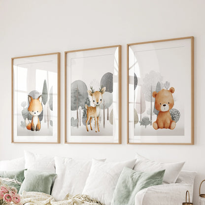 Three matted prints of a fox, fawn, and bear in natural wood frames line the living room wall above the sectional seating.
