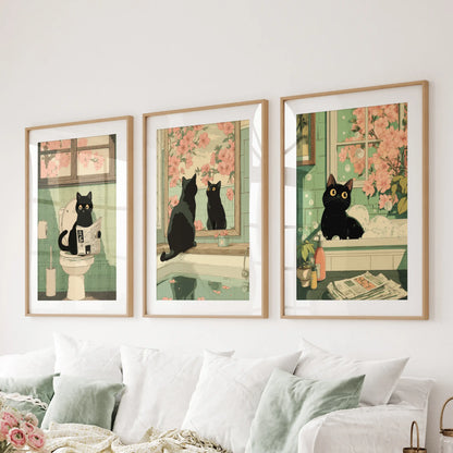 Vintage Japanese cat bathroom posters, 3-piece wall hanging set, in natural wood matted frames positioned behind the couch in the lounge.