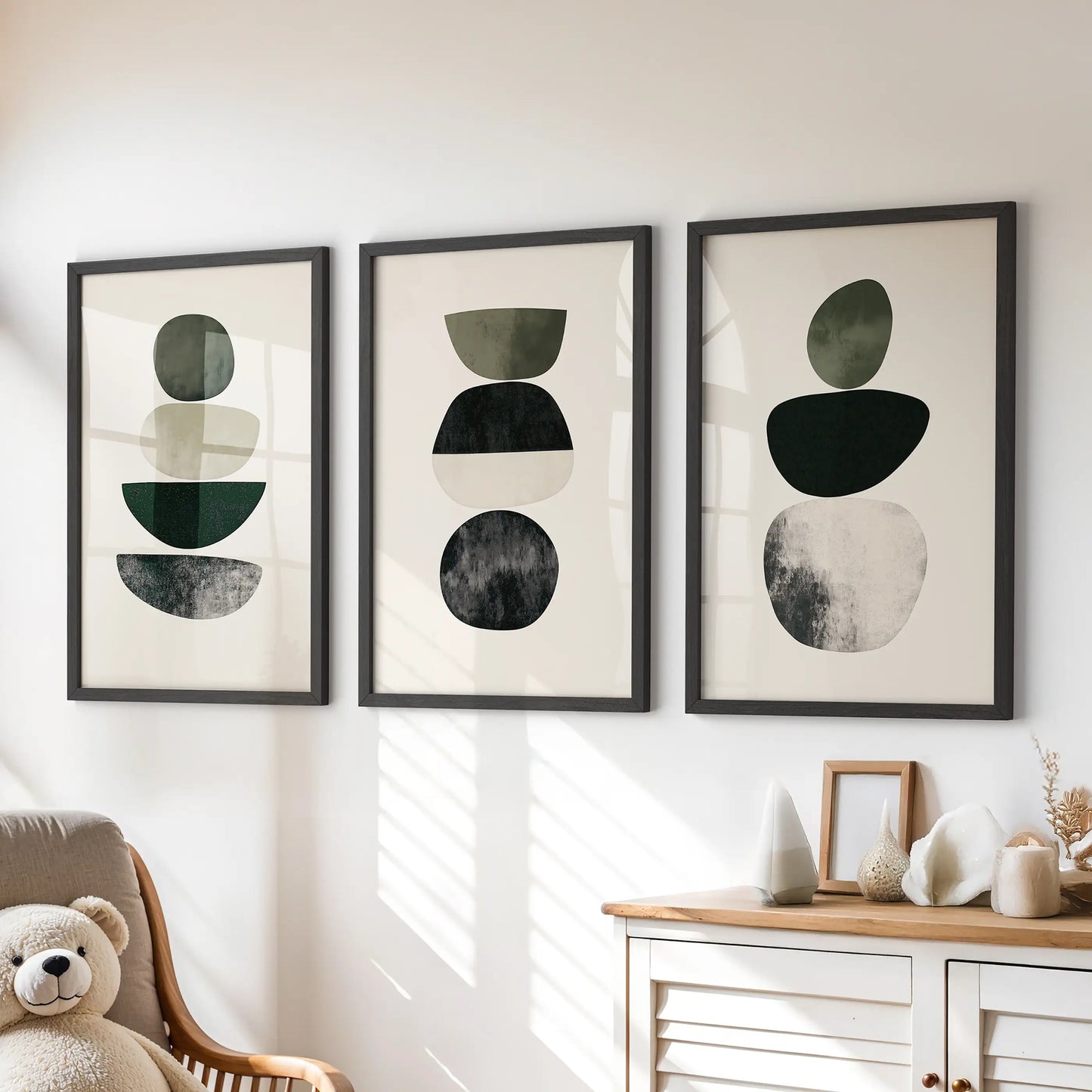 Japandi minimalist shapes 3-piece picture set creates soft wall art for a kids playroom, with black frames set neatly over the dresser.