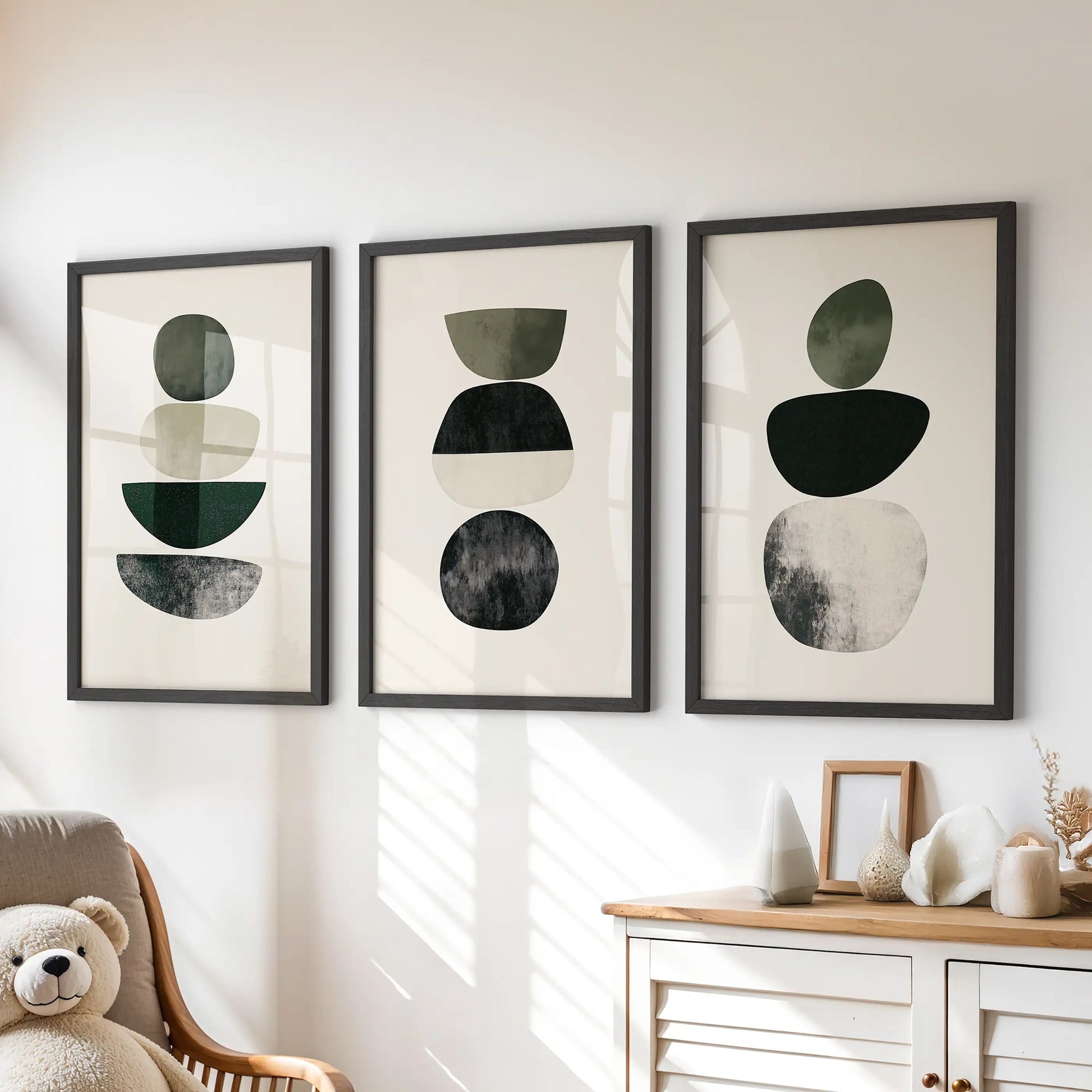 Japandi minimalist shapes 3-piece picture set creates soft wall art for a kids playroom, with black frames set neatly over the dresser.