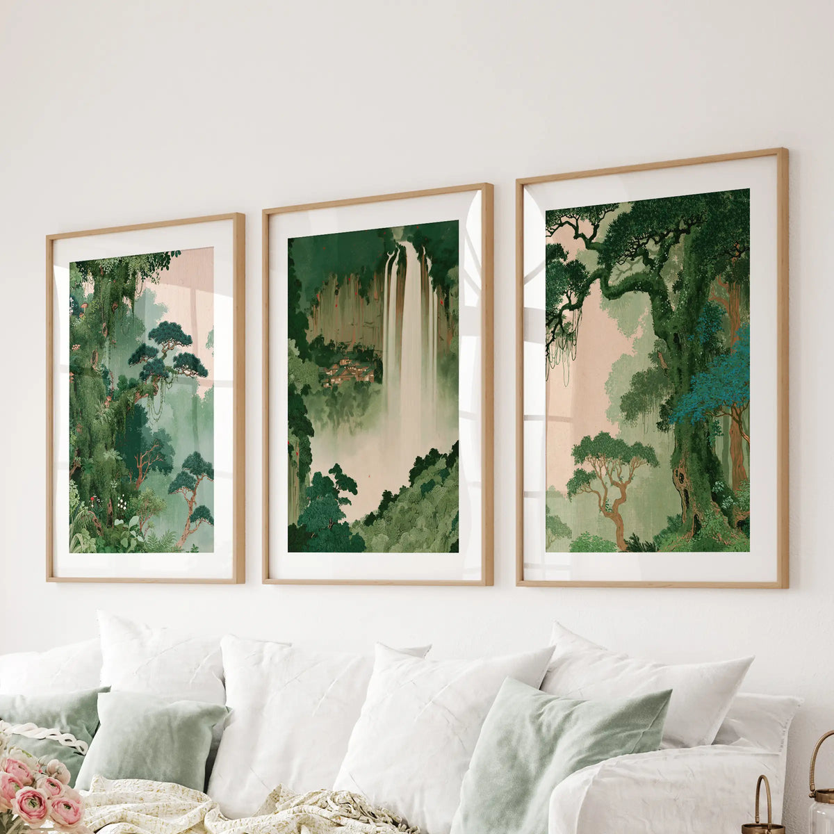 Japanese forest wall art set of three matted prints in thin wood frames, displayed above a couch in a family room.