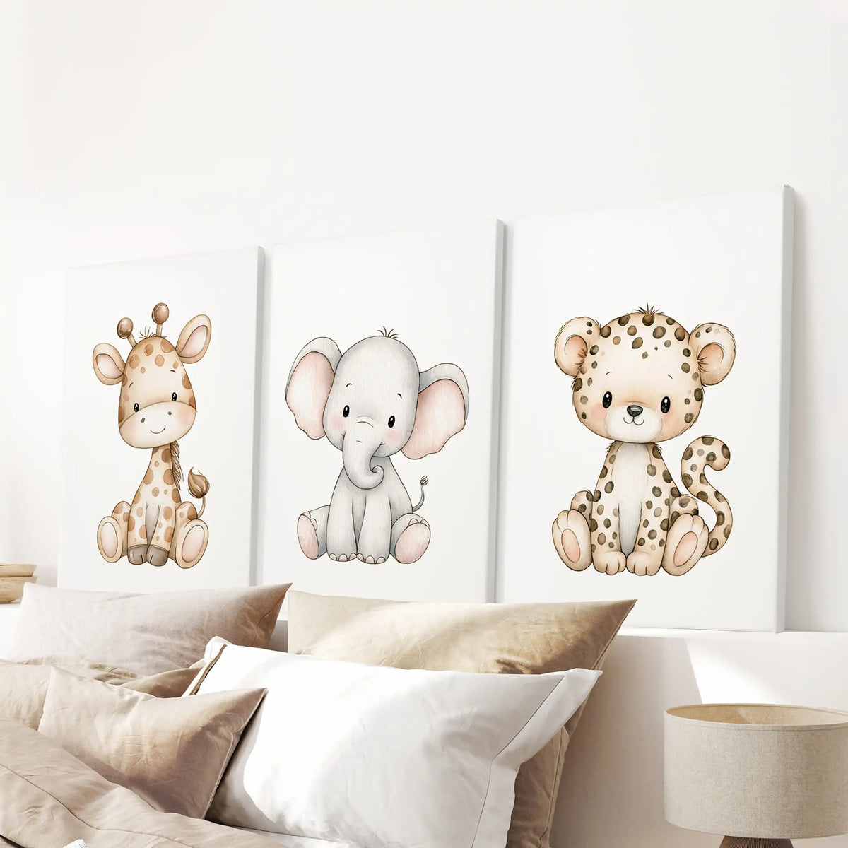 A baby giraffe, elephant and leopard are pictured on three canvases above a bed.
