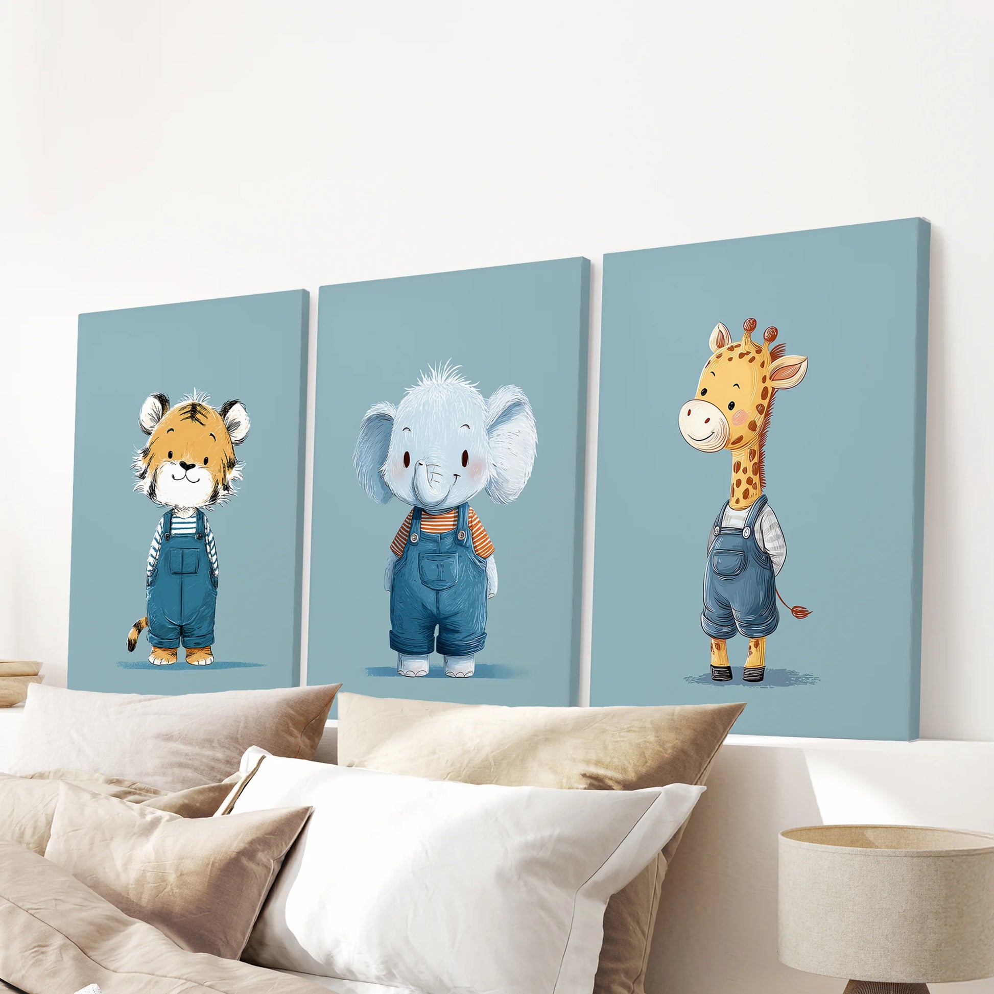 Three stretched canvas prints of blue safari animals hang over a bedroom headboard, giving the space calm, playful energy.