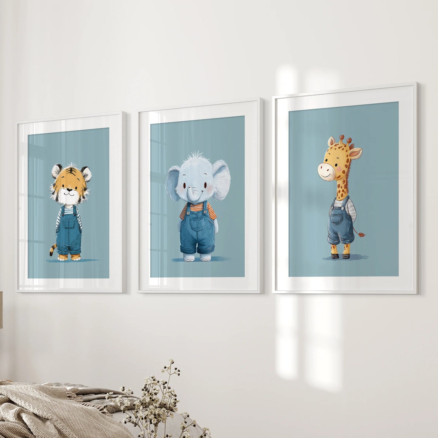 A calm trio of blue safari wall prints in white-matted frames sits next to the bedroom bed, creating a restful nighttime touch.