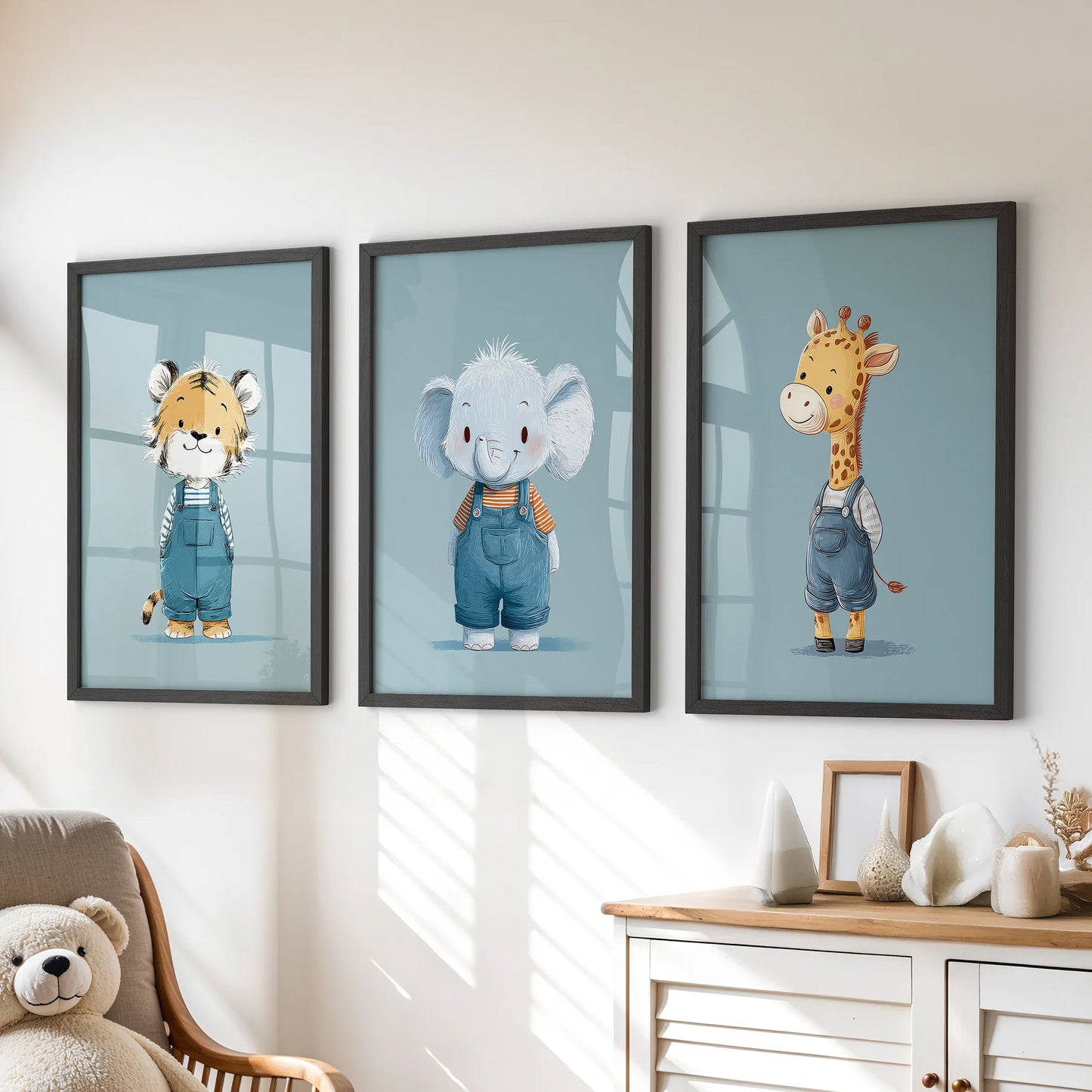Blue safari animals in a three-piece wall art set, black-framed and styled above a kids room dresser for a cheerful, tidy look.