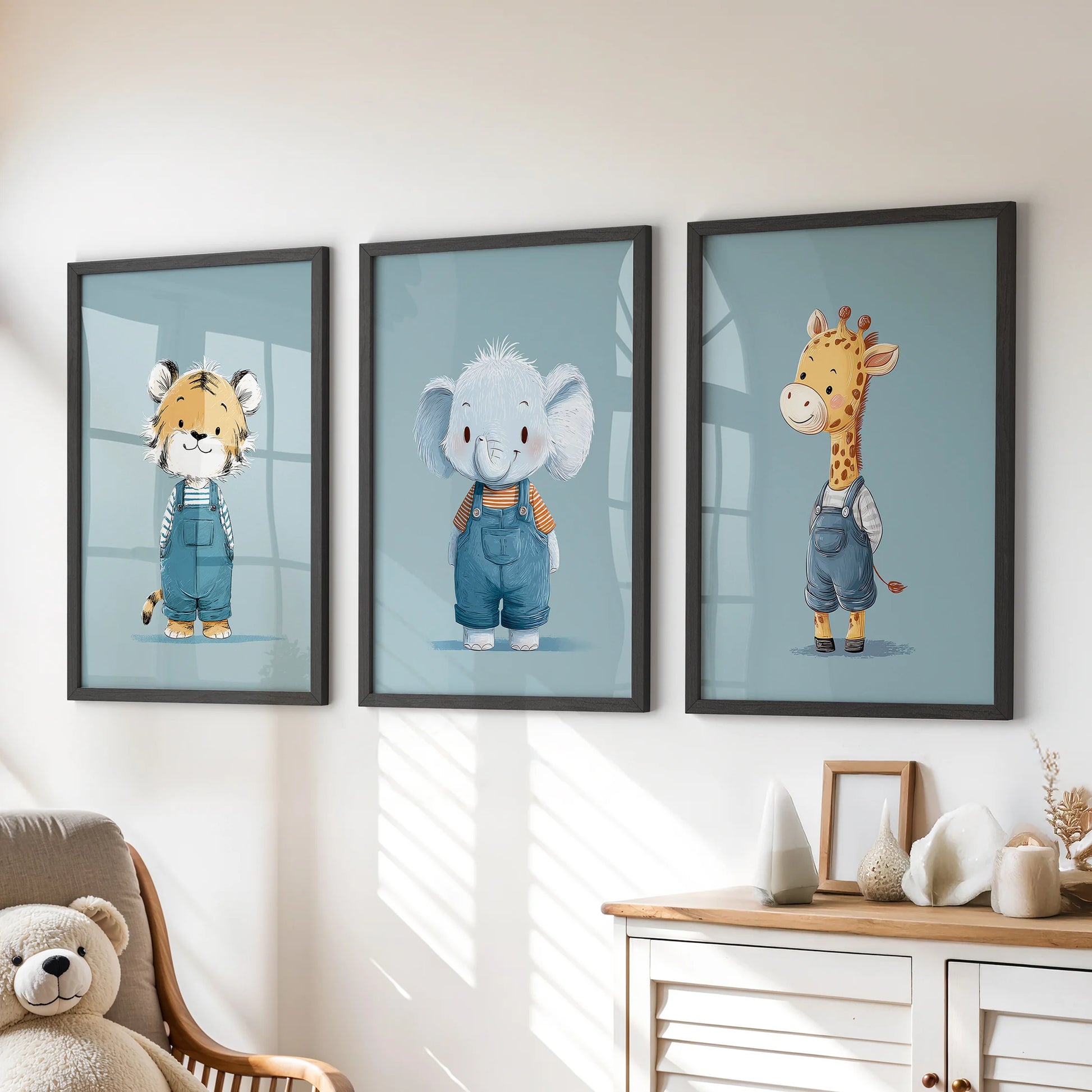 Blue safari animals in a three-piece wall art set, black-framed and styled above a kids room dresser for a cheerful, tidy look.