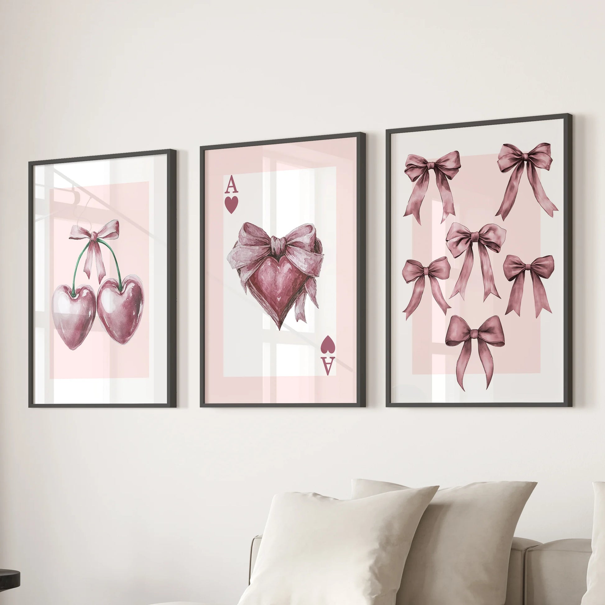 Pink bows three-piece artwork set in black frames floats over the sectional in the sitting room, giving the coquette look a soft, graphic lift.