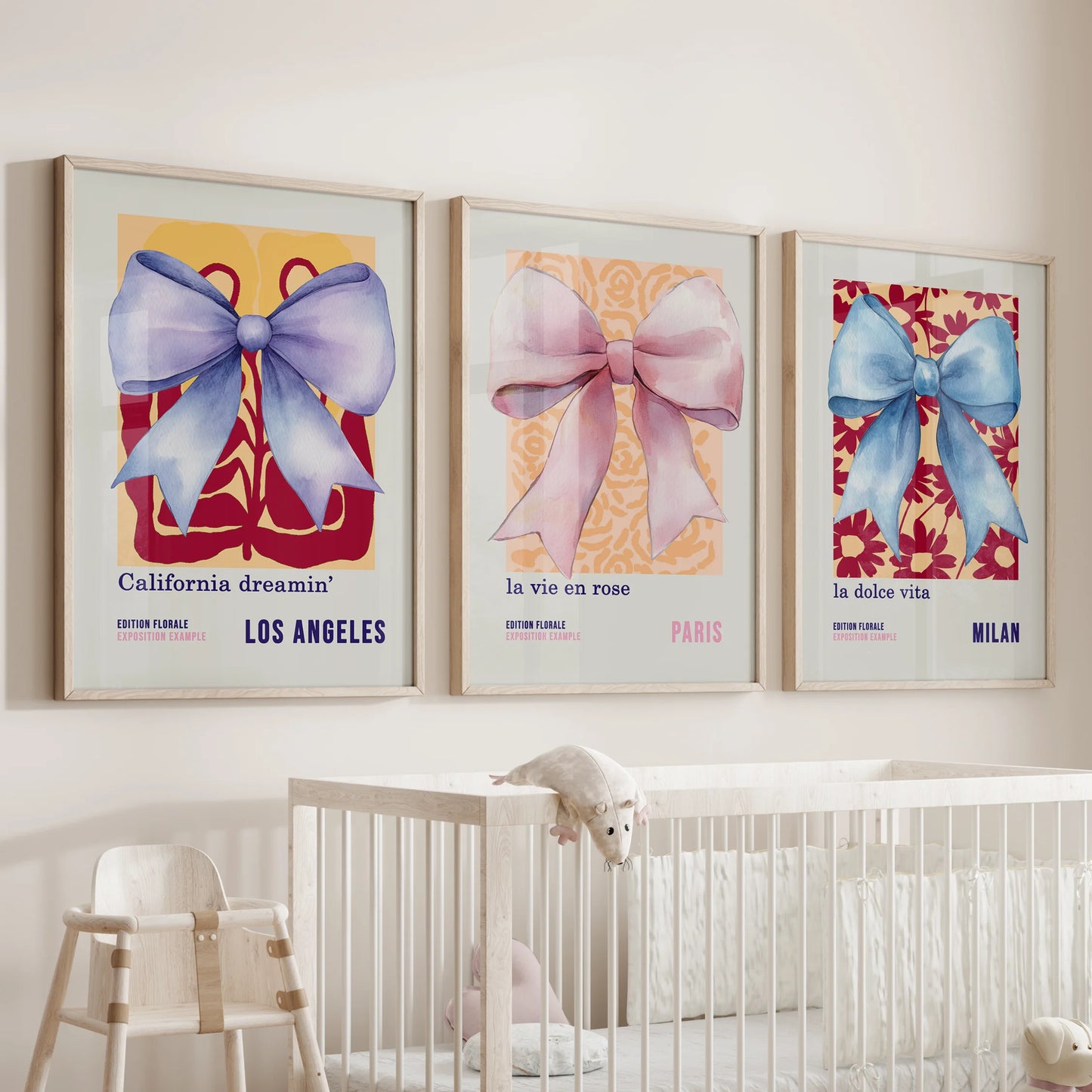 A trio of ribbon-bow prints in delicate thin wood frames floats above the nursery bassinet, creating a calm, storybook accent.