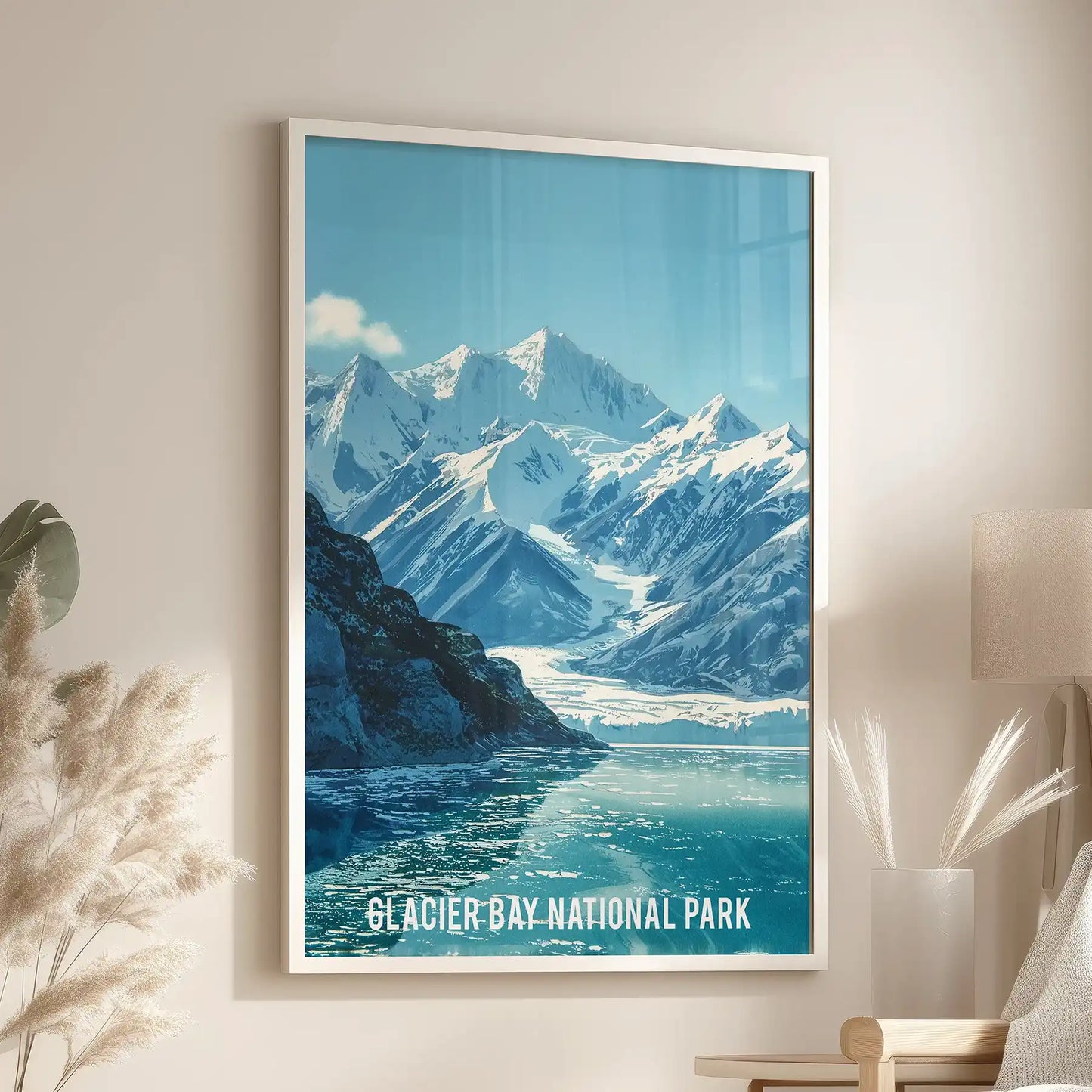 A framed landscape print of Alaska’s winter coast hangs over the living-room armchair, its white frame accenting the calm, cool tones.