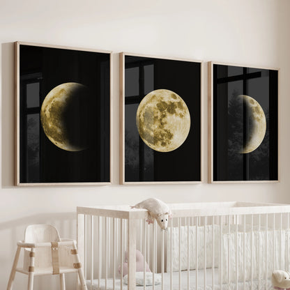 A baby room wall decor set of three wooden-framed moon prints hangs above the cot, the lunar cycle gently soothing the space.