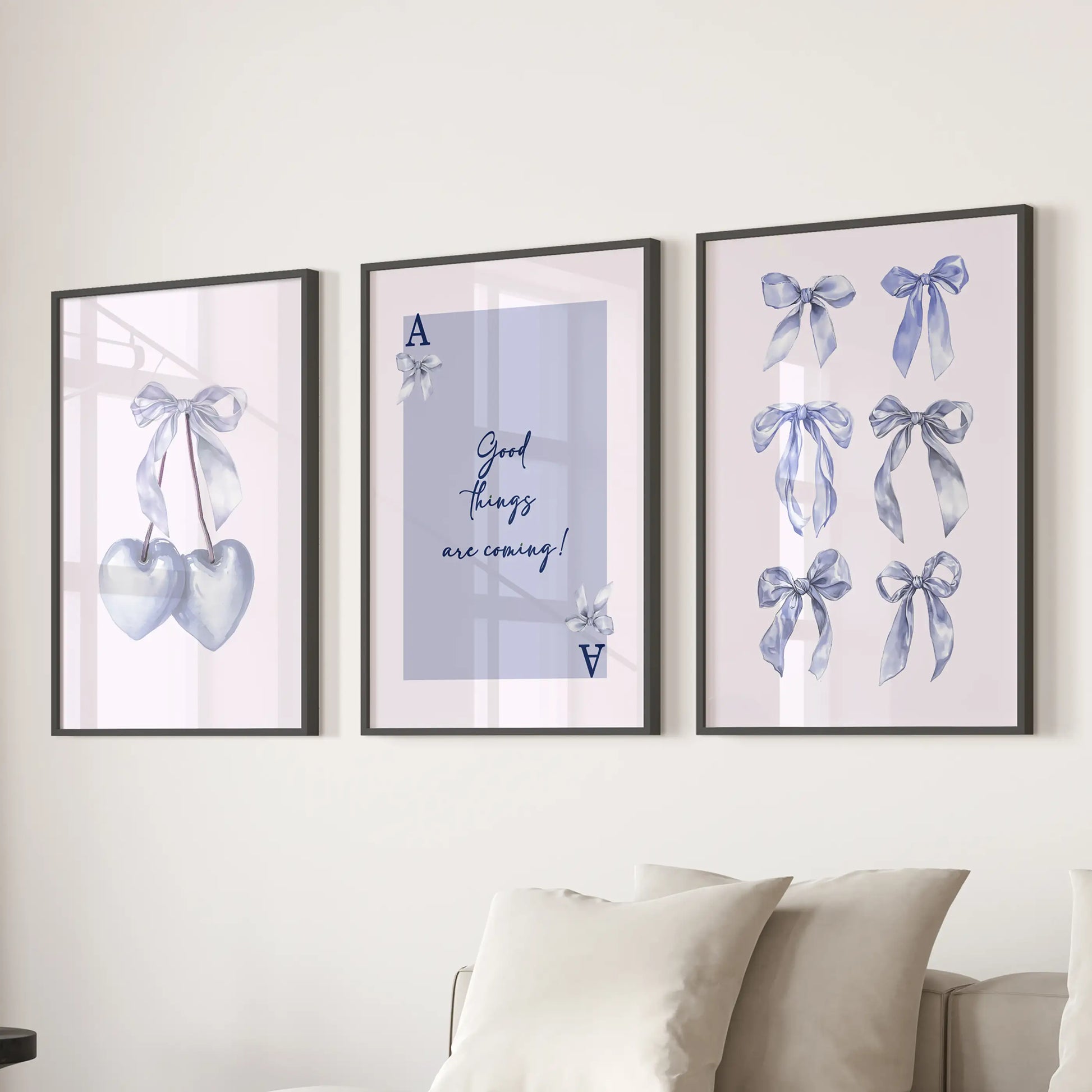 Good Things Are Coming quote wall prints, set of three, bring airy light-blue optimism in black frames hung over the sectional in a welcoming family room.