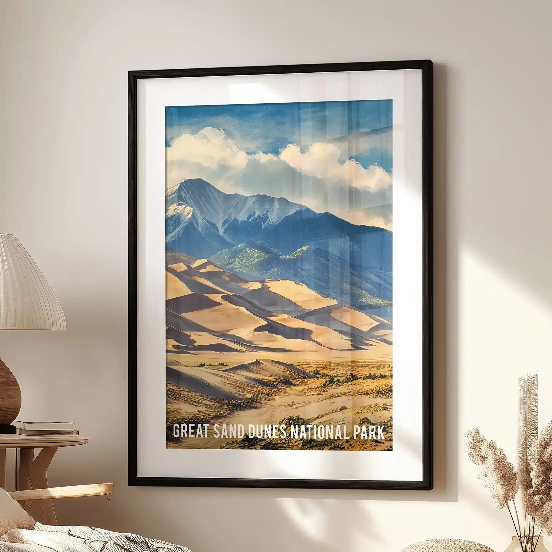 San Luis Valley desert and mountains wall poster in a black frame with white mat, styled over a cozy lounge chair for a crisp, modern nod to the dunes.