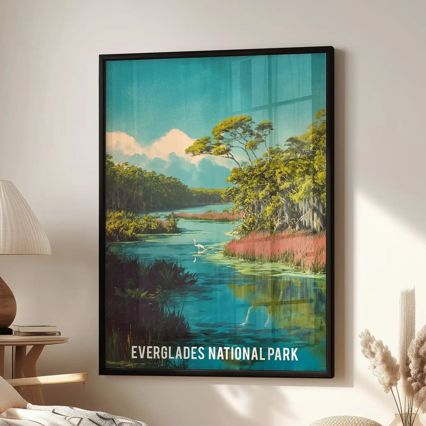 Everglades National Park landscape single panel poster in a black frame hangs in the sitting room above a cozy chair, bringing cool green-blue calm.