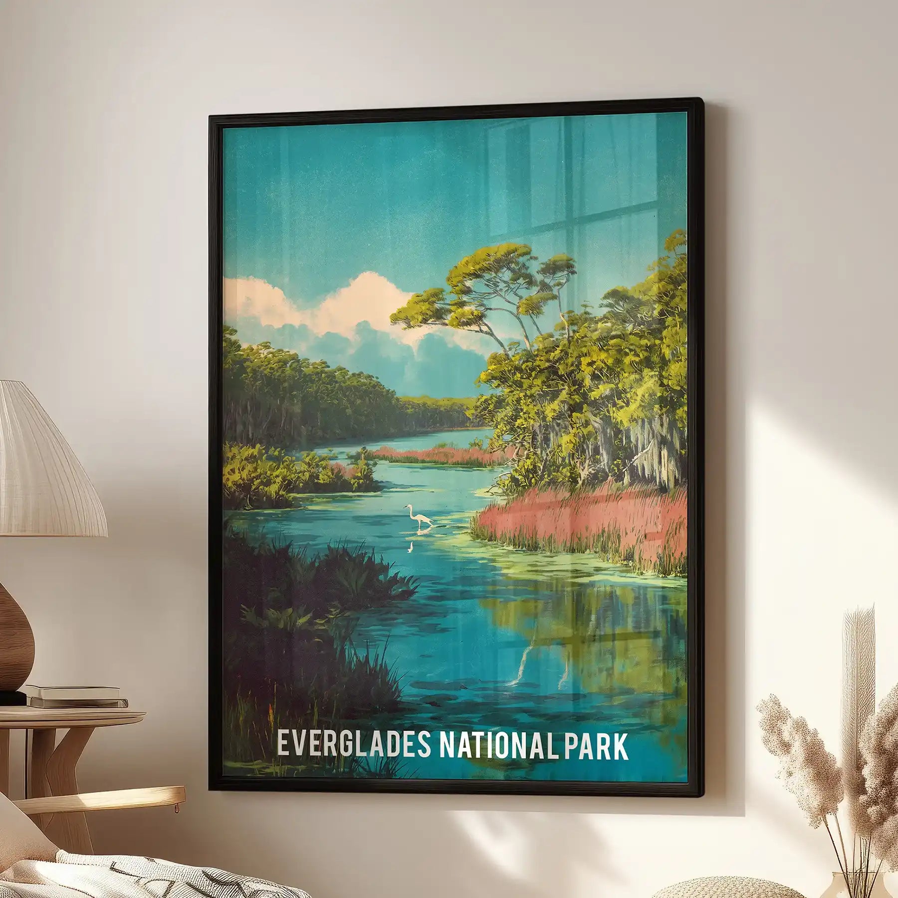 Everglades National Park landscape single panel poster in a black frame hangs in the sitting room above a cozy chair, bringing cool green-blue calm.