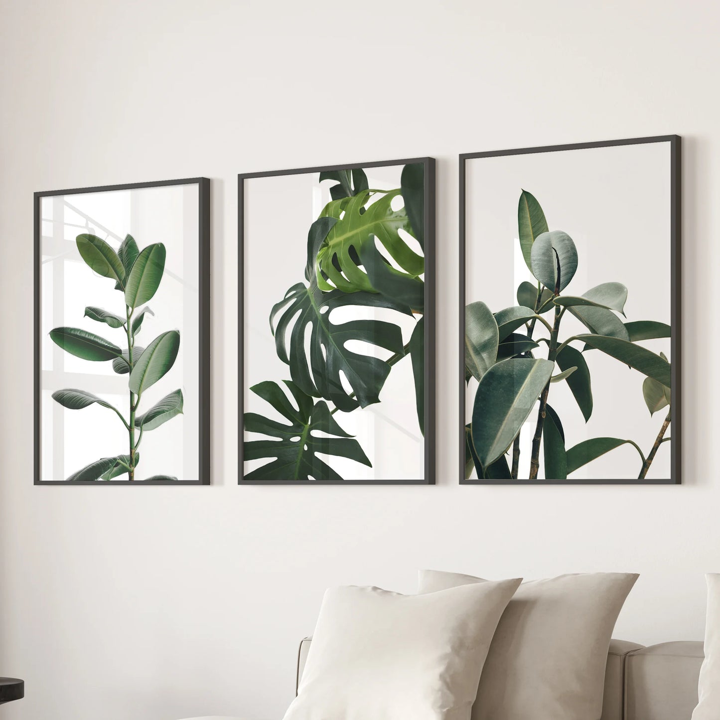 Rubber plant leaves, a print set of 3 black-framed wall pieces, grounds the family room with deep greens, arranged above the sectional for balanced calm.