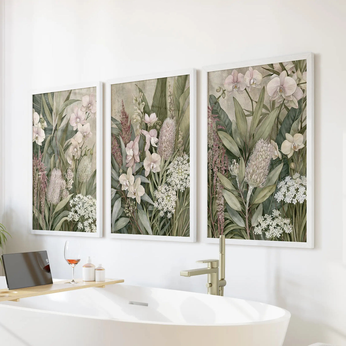 White frames surround three prints above a bathtub, with pale orchid petals beside tall pink flower spikes and upright leaves.