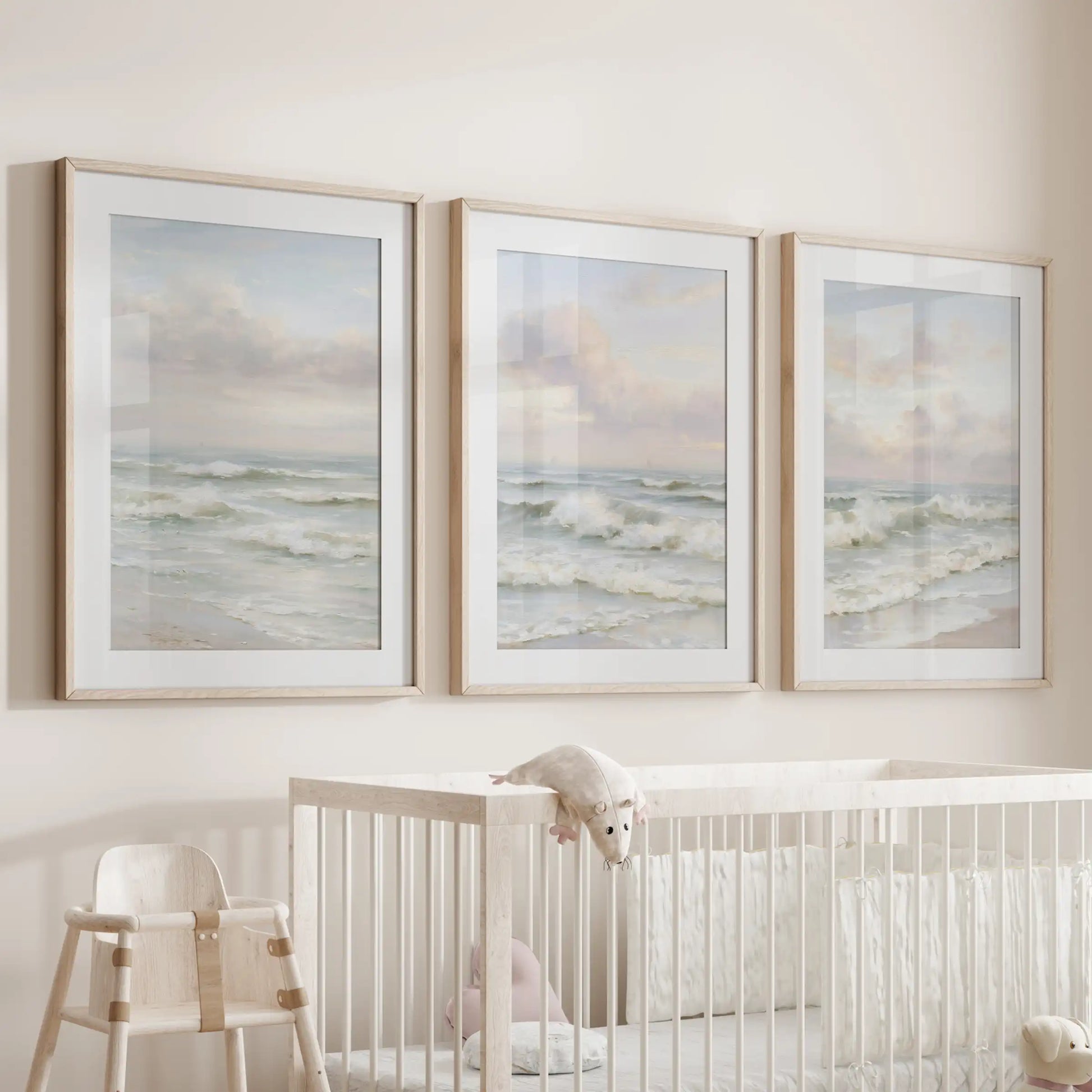 Calm coastal waters, a set of three prints matted and set in warm wood frames, soothe the infant room when hung over the cot.