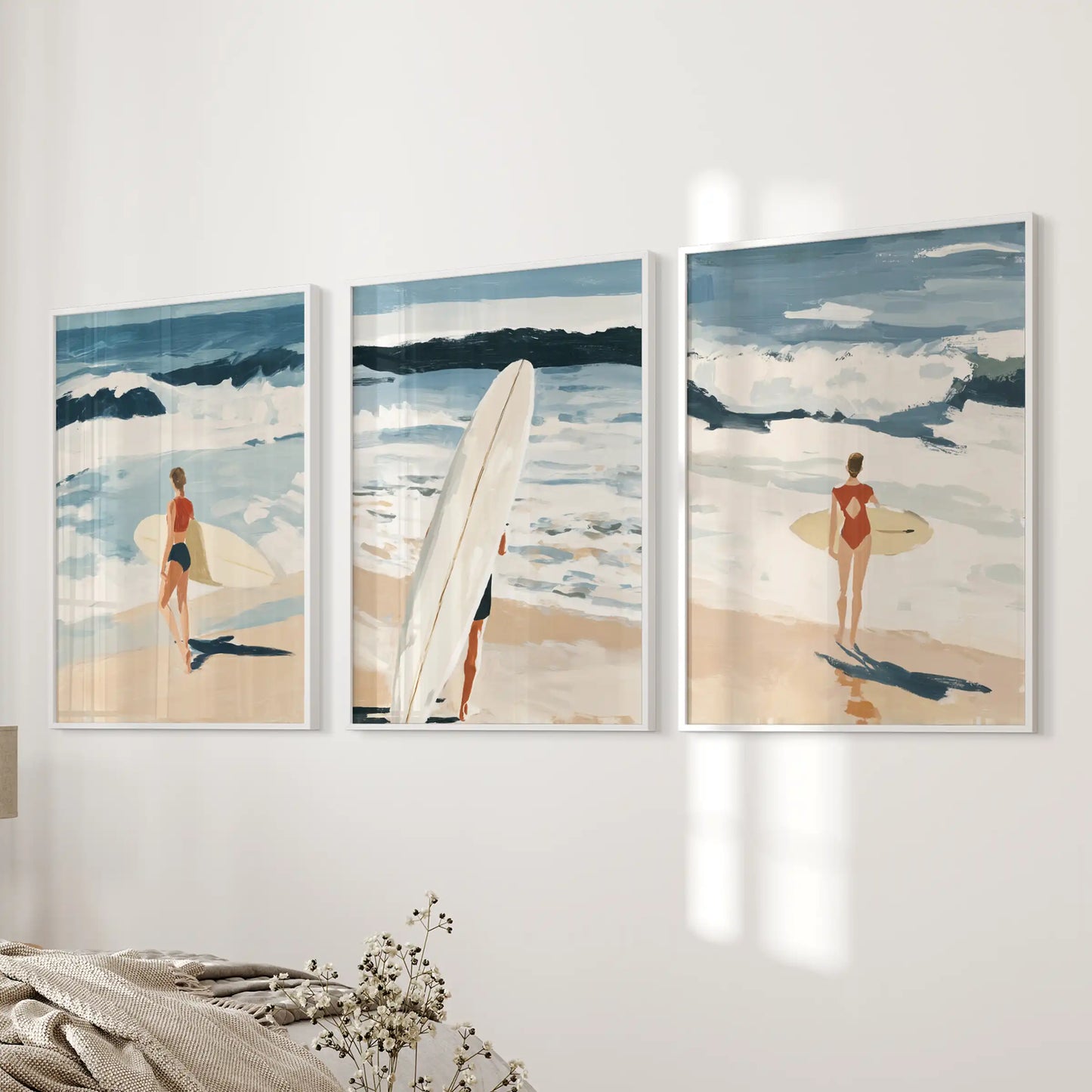 Surfer scenes, a 3-piece poster set in white framed prints, adds an easy summer note near the bed wall in the bedroom.