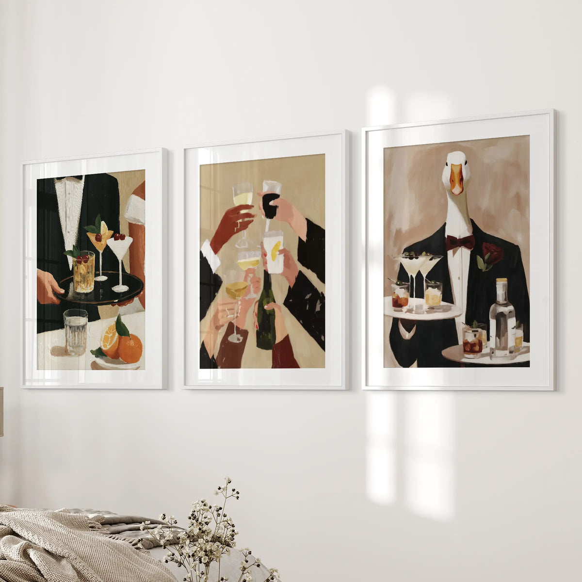 Happy hour wall art in a set of 3, hung beside the bed in white frames with mats in a bedroom.