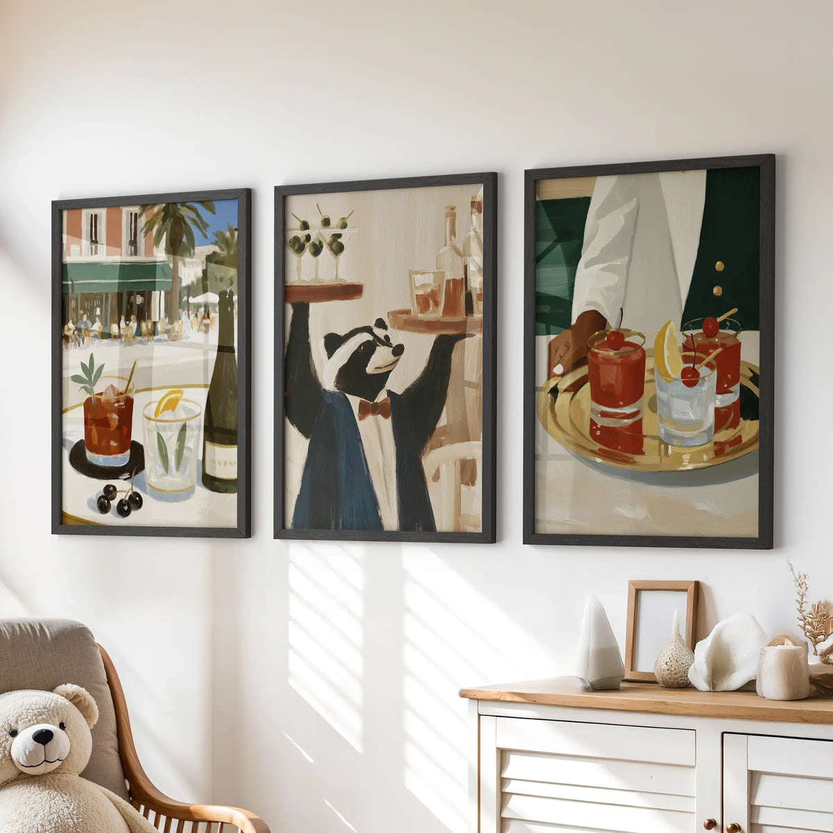 Happy hour drinks in a set of three wall prints, black framed over a dresser in a children's room.