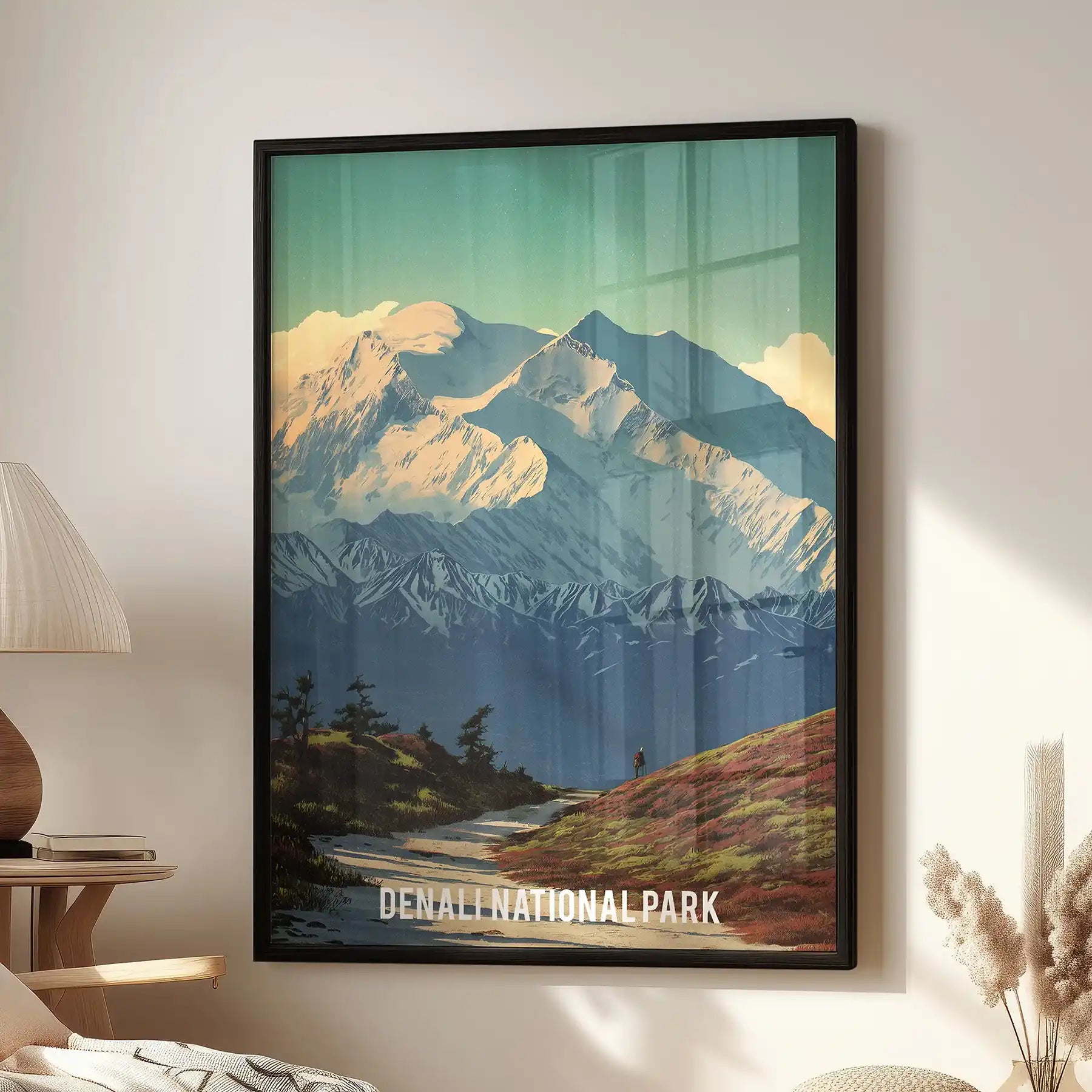 A standalone wall poster of Denali’s glacier peaks in a sleek black frame, brightening the sitting room beside a modern accent chair.