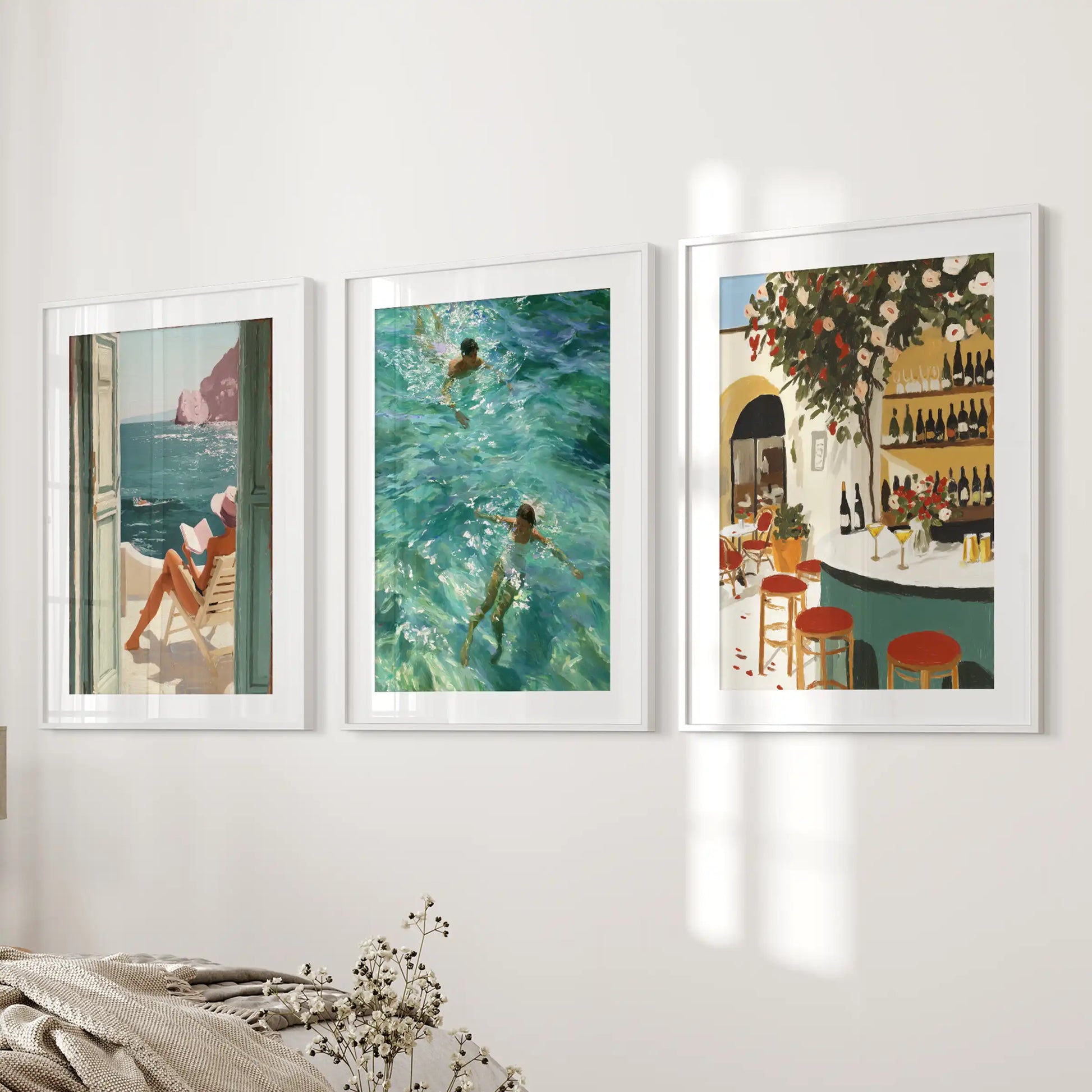 Amalfi Coast seascapes, three-part wall art with white matted frames, set along the bedroom wall beside the bed for relaxed, sunlit charm.