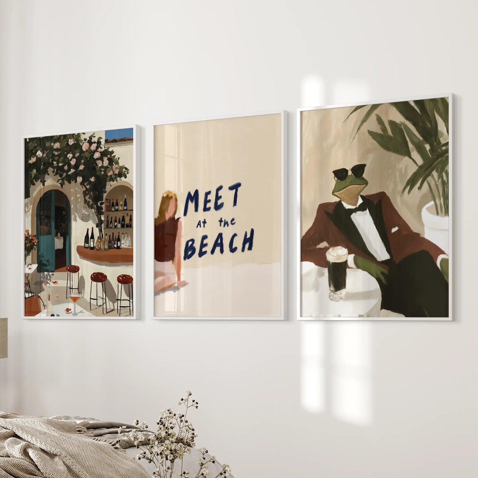 An Italian café triptych in white frames warms a bedroom wall with simple charm and a gentle, uncluttered character.