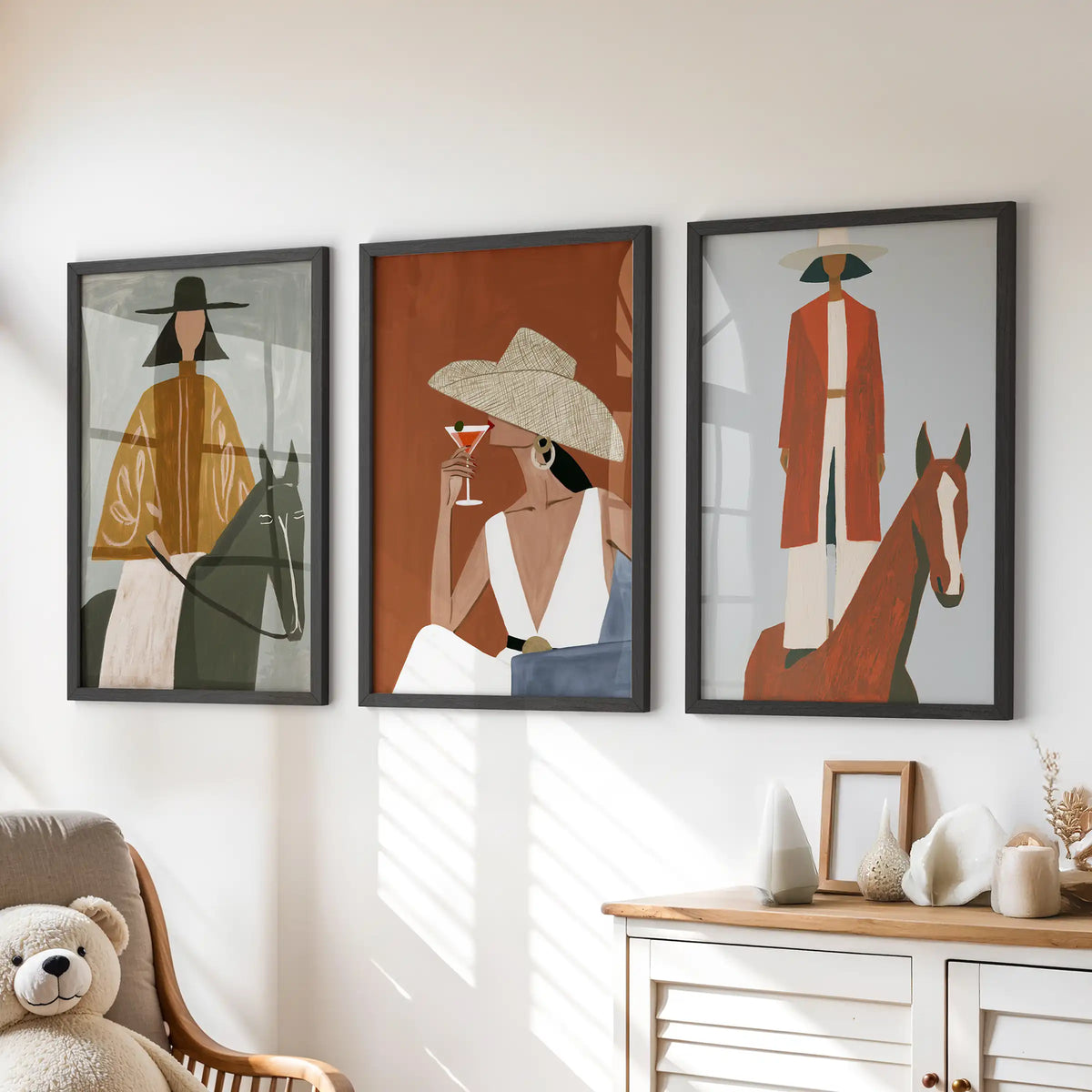 Cowgirl fashion silhouettes, a gallery wall of 3 prints in black frames, add friendly western spirit above the kids' chest of drawers.