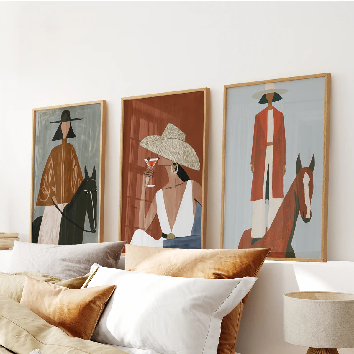 Cowgirl fashion silhouettes, wall art in three pieces with oak-framed prints, centers the bedroom above the bed headboard.