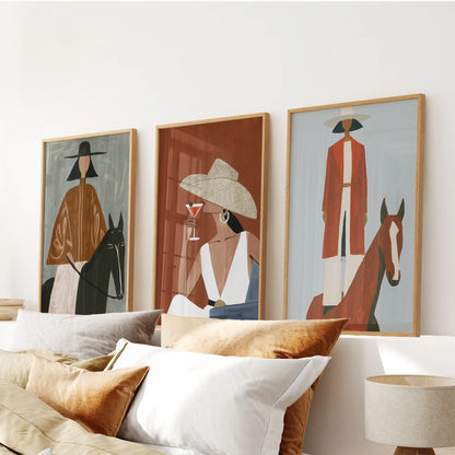 Cowgirl fashion silhouettes, wall art in three pieces with oak-framed prints, centers the bedroom above the bed headboard.