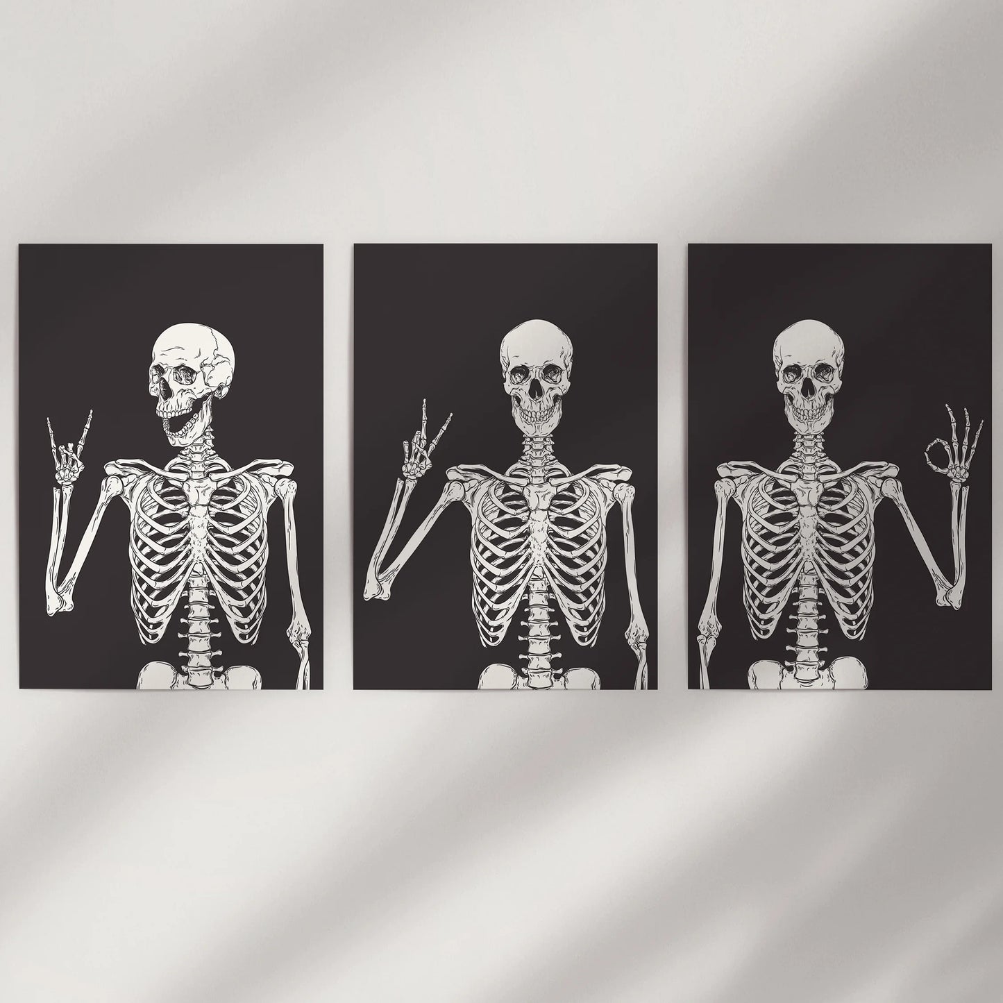 This witty wall art set of three skeleton prints appears clean and modern on a white wall, adding a crisp, playful Halloween note.