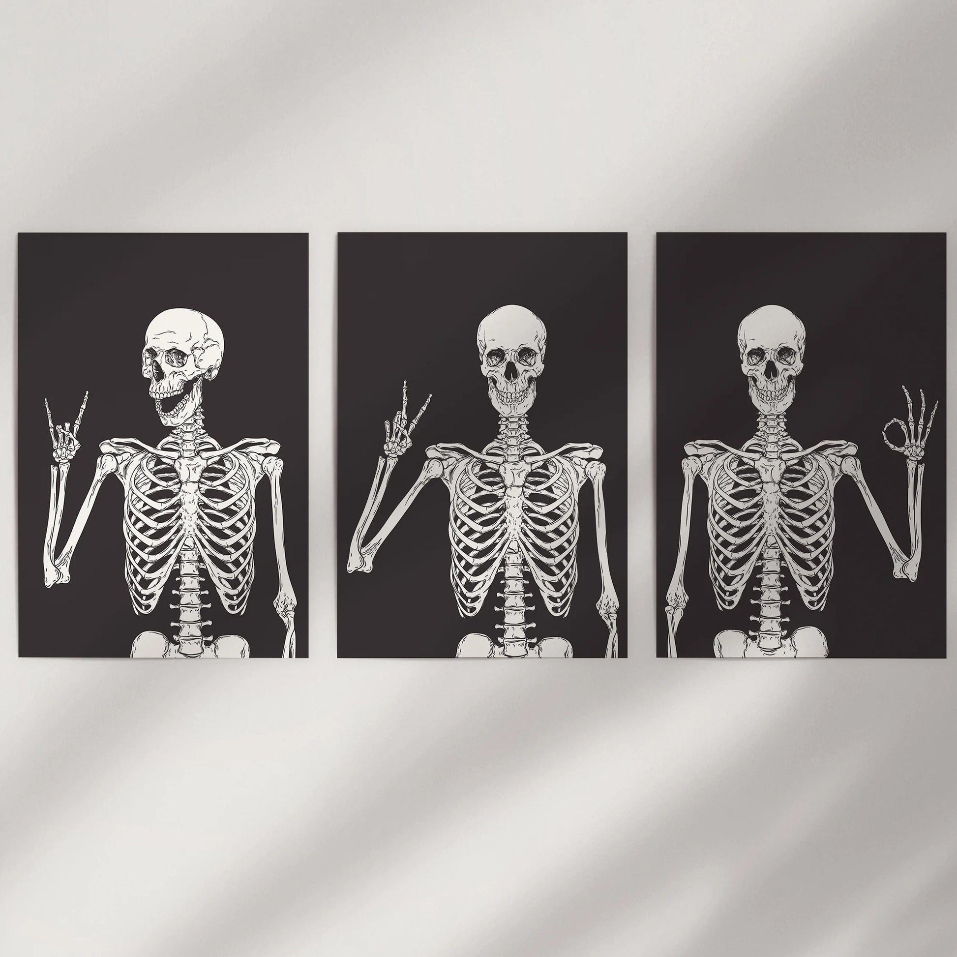 This witty wall art set of three skeleton prints appears clean and modern on a white wall, adding a crisp, playful Halloween note.