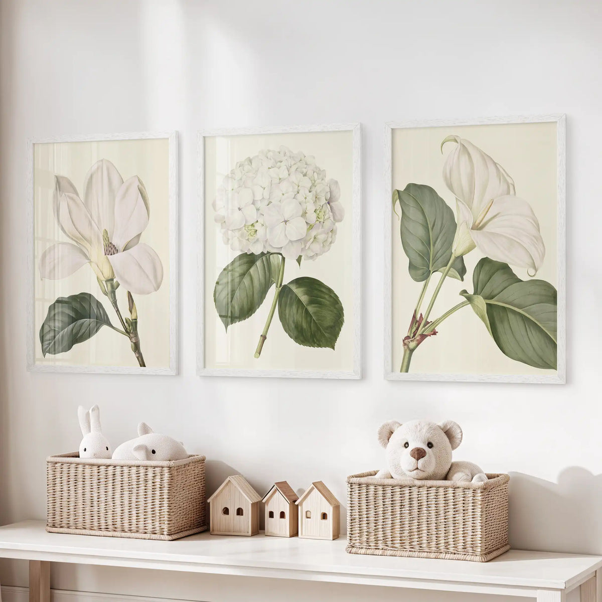 The three white-framed prints above toy baskets show a white hydrangea between two larger open blooms, each with green leaves.