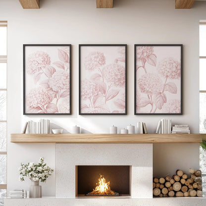 Pink hydrangea patterns fill three black-framed prints above a fireplace.