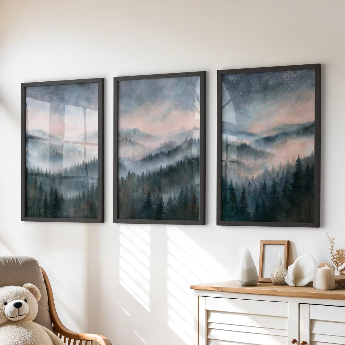 Three misty mountain forest prints form a wall art set in black frames, creating a calm focal point above the playroom dresser.