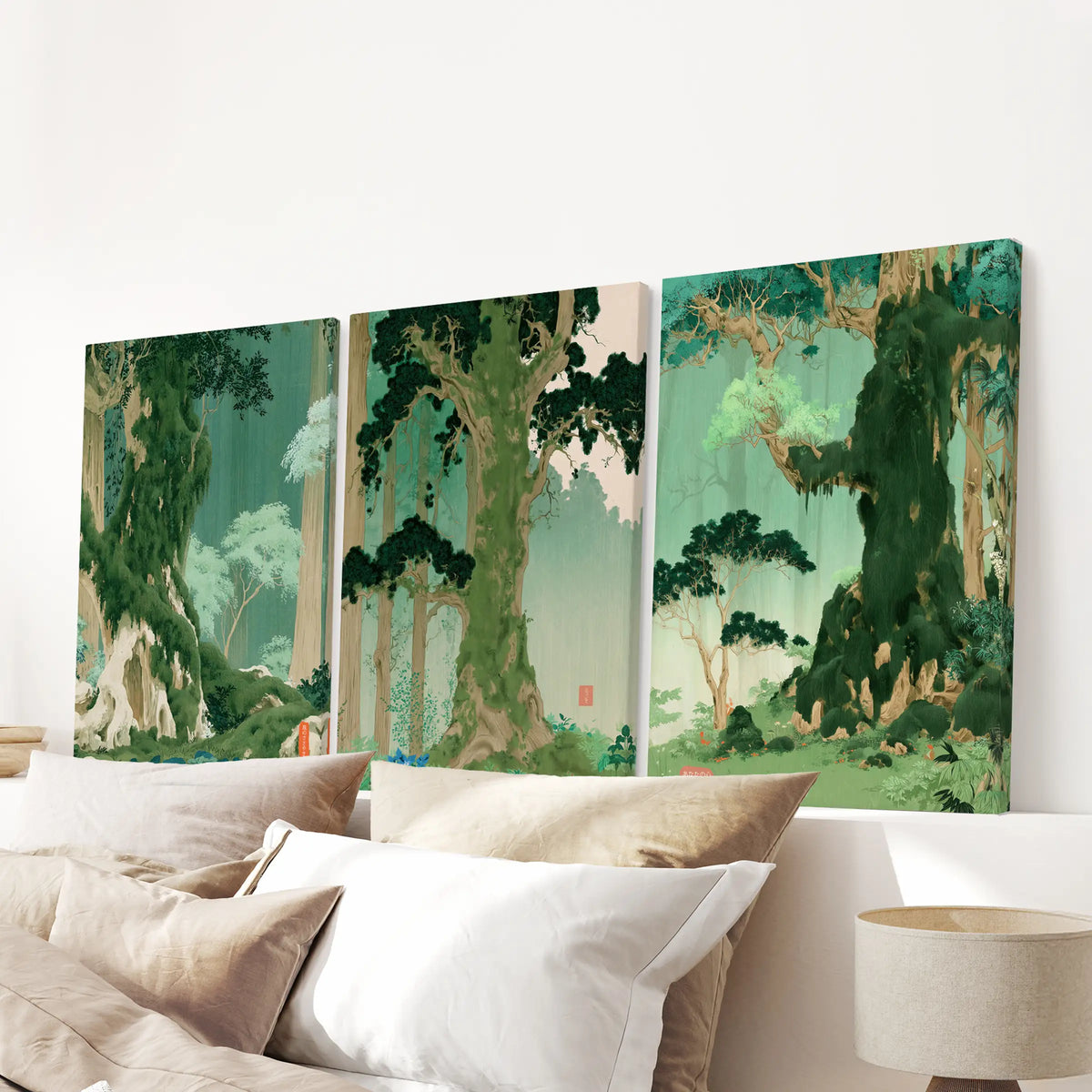 A three-piece Japanese nature landscape stretched canvas set hangs over the headboard in a bedroom.