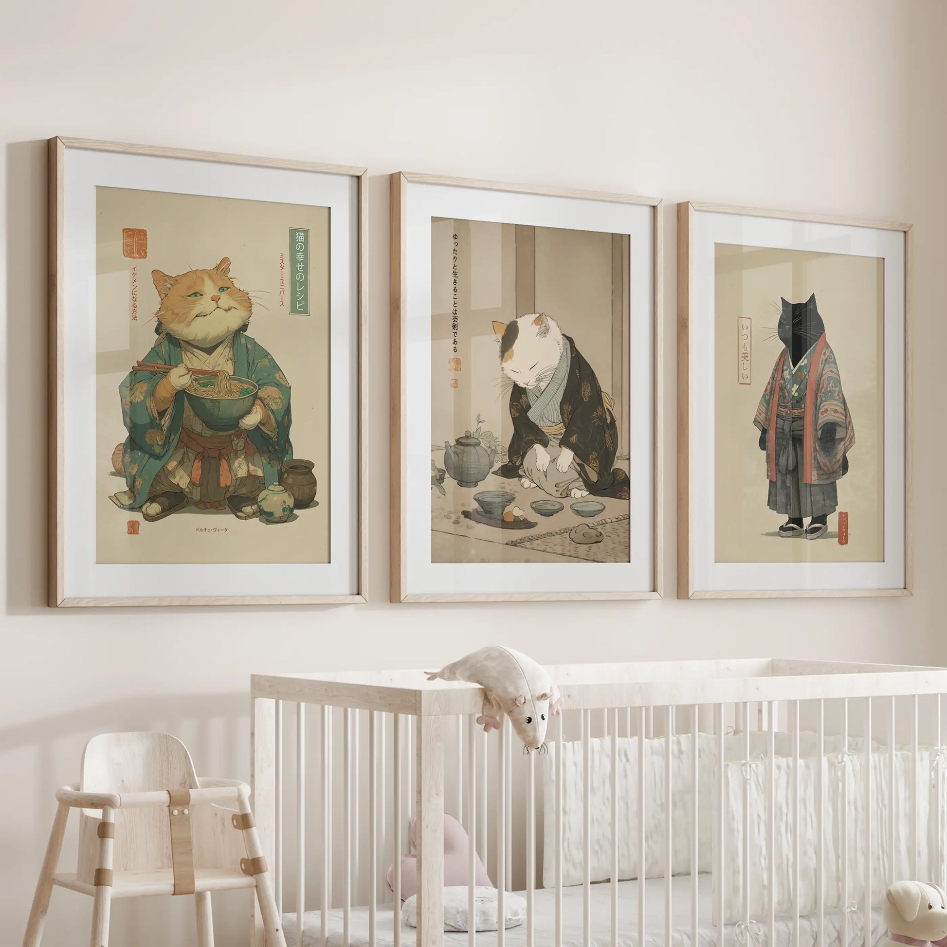 Three oak-framed Japandi cat prints, softly matted, hang above the cot and lend gentle warmth and natural tone to the baby's room.